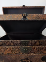 Set of two elegant bronze leather decorative storage boxes with embossed rose patterns, stacked for display in a vintage style interior