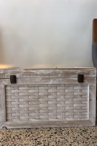 Vintage Indian storage chest made of wood with a bleached white hand-painted finish and woven rattan-style panels on the exterior