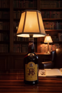 Handmade side lamp crafted from a J&B repurposed spirit bottle with a fabric lampshade, displayed as unique sustainable lighting decor