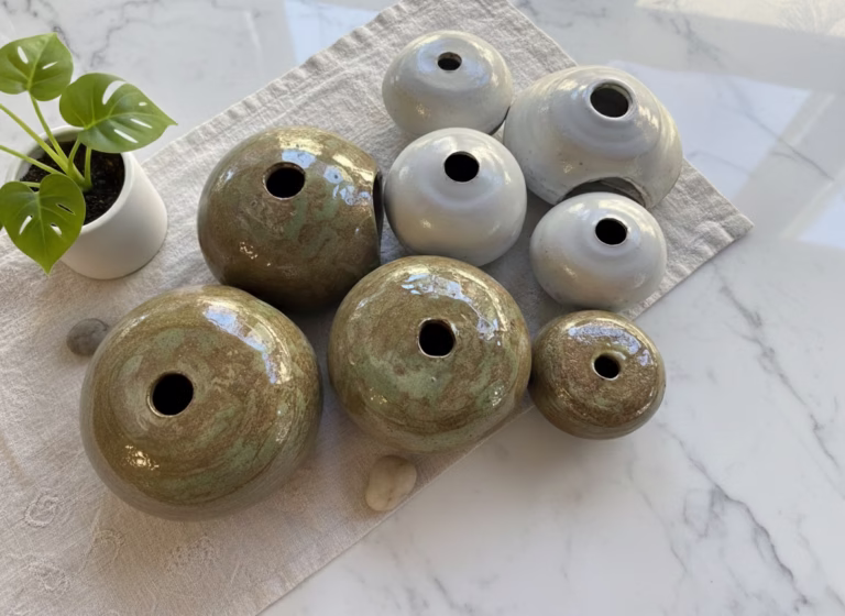 Transform your shelves with this set of 8 handmade ceramic orbs. Featuring a mix of Japandi-style sage and matte white glazes, these artisanal sculptures are the perfect minimalist table centerpiece in Lebanon. Order your set from Rockfort.