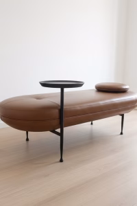 Contemporary 162cm capsule-shaped bench in black cow leather with an integrated matte black steel side table, modern furniture for a luxury entryway