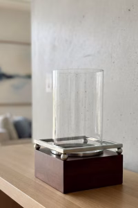 Modern rustic hurricane candle holder with a dark wood base, spherical metal feet, and a large glass cylinder sleeve, 42.5cm tall