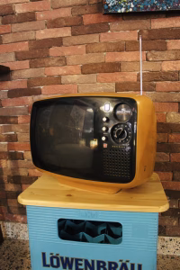 Vintage 1970s Panasonic TR-542A Space Age television in mustard yellow ochre, featuring a rounded solid state body and original knobs