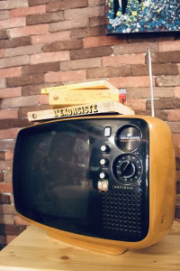 Vintage 1970s Panasonic TR-542A Space Age television in mustard yellow ochre, featuring a rounded solid state body and original knobs