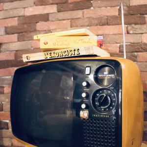 Vintage 1970s Panasonic TR-542A Space Age television in mustard yellow ochre, featuring a rounded solid state body and original knobs