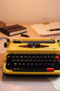 Vintage 1970s Brother Deluxe 600 Nogamatic portable typewriter in bright canary yellow, Japanese mechanical engineering, retro office decor