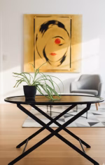 Luxury oval black leather folding table with visible perimeter stitching and black metal X-frame, styled in a modern masculine library or lounge