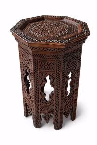 Hand-carved Damascus style miniature accent table featuring an octagonal top with geometric relief and an arched fretwork base from RockFort Lebanon.