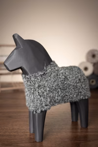 Modern minimalist wooden horse sculpture with a matte black finish and a hand-knitted textured wool coat from RockFort decor boutique in Lebanon.