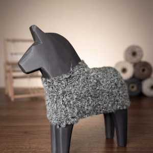 Modern minimalist wooden horse sculpture with a matte black finish and a hand-knitted textured wool coat from RockFort decor boutique in Lebanon.