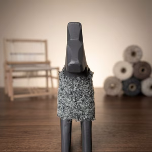 Modern minimalist wooden horse sculpture with a matte black finish and a hand-knitted textured wool coat from RockFort decor boutique in Lebanon.