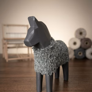Modern minimalist wooden horse sculpture with a matte black finish and a hand-knitted textured wool coat from RockFort decor boutique in Lebanon.