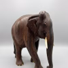 Hand-carved solid wood elephant sculpture with detailed natural grain, delicate inlay work on the feet, and polished tusks from RockFort Lebanon.