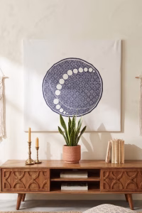 Large hand-embroidered textile wall hanging featuring a navy blue circular mandala and moon-phase design on a white fabric base from RockFort boutique in Lebanon.