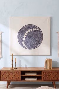 Large hand-embroidered textile wall hanging featuring a navy blue circular mandala and moon-phase design on a white fabric base from RockFort boutique in Lebanon.