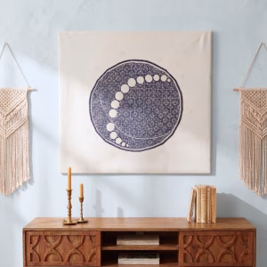 Large hand-embroidered textile wall hanging featuring a navy blue circular mandala and moon-phase design on a white fabric base from RockFort boutique in Lebanon.