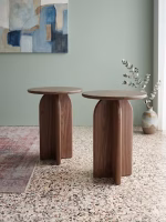 Handmade solid walnut side table featuring a smooth round top and a unique sculptural architectural base from RockFort design store in Lebanon.