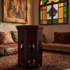Hand-carved Damascus style miniature accent table featuring an octagonal top with geometric relief and an arched fretwork base from RockFort Lebanon.