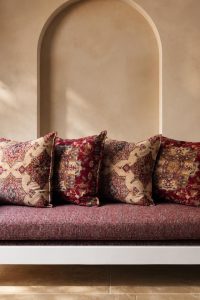 Traditional Moroccan style 3-seater wooden sofa with a solid white frame and patterned boho fabric upholstery from RockFort furniture store in Lebanon.