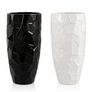 Pair of tall geometric ceramic floor vases in glossy black and glossy white with a faceted crystal pattern from RockFort Lebanon.