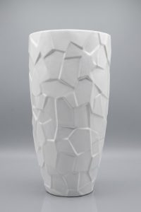 Tall glossy white ceramic floor vase with a faceted shattered-crystal surface on a grey background from RockFort Lebanon.